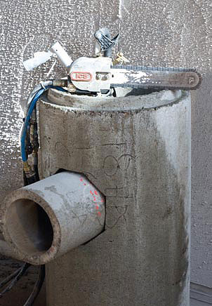 A smaller concrete pipe inserted into the octagonal hole cute out of a large concrete pipe