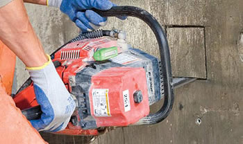 Chain saw cutting a square shape into a concrete wall